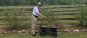 Guy standing in his garden with Gorilla cart