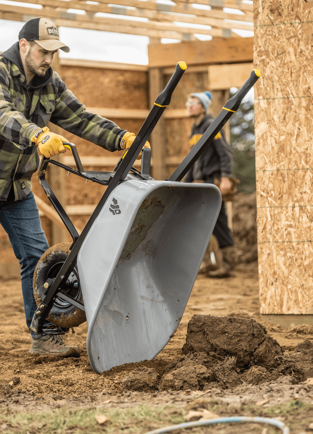 Man dumping dirt out of a GSXD-6 Wheelbarrow